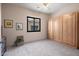 Neutral bedroom featuring a murphy bed, window, dresser and fan providing a flexible living space at 7445 E Eagle Crest Dr # 1015, Mesa, AZ 85207
