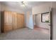 Neutral bedroom featuring a murphy bed, window, and fan providing a flexible living space at 7445 E Eagle Crest Dr # 1015, Mesa, AZ 85207