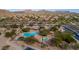 Aerial view of the community pools and park, with desert landscaping and shaded seating areas at 7445 E Eagle Crest Dr # 1015, Mesa, AZ 85207
