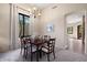 Bright dining area featuring a chandelier, large window, and seating for six, perfect for Gathering meals at 7445 E Eagle Crest Dr # 1015, Mesa, AZ 85207