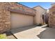 Exterior of house with garage, beautiful stonework, and desert landscaping at 7445 E Eagle Crest Dr # 1015, Mesa, AZ 85207