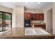 Open kitchen featuring granite countertops, white porcelain sink, and a sliding door to the outdoor patio at 7445 E Eagle Crest Dr # 1015, Mesa, AZ 85207