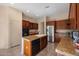 Well-equipped kitchen featuring ample cabinetry, stainless steel appliances, granite countertops, and an island with a sink at 7445 E Eagle Crest Dr # 1015, Mesa, AZ 85207