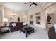 Spacious living room with a fireplace, elegant decor, plush seating, and a dining area visible through an archway at 7445 E Eagle Crest Dr # 1015, Mesa, AZ 85207
