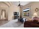 Comfortable living area featuring a ceiling fan, large window, and a view into other parts of the home at 7445 E Eagle Crest Dr # 1015, Mesa, AZ 85207