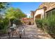 Outdoor patio featuring stone pavers, patio furniture, and lush landscaping with mature shrubs and trees at 7445 E Eagle Crest Dr # 1015, Mesa, AZ 85207