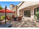 Inviting outdoor patio with comfortable seating and an orange umbrella, perfect for relaxation and entertaining guests at 7445 E Eagle Crest Dr # 1015, Mesa, AZ 85207