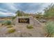 Elegant community entrance sign with stone landscaping and native plants at 7445 E Eagle Crest Dr # 1015, Mesa, AZ 85207