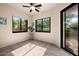 Bright sun room with tile floors, ceiling fan, large windows and sliding glass door to outdoor patio at 7445 E Eagle Crest Dr # 1015, Mesa, AZ 85207