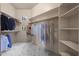 Organized walk-in closet featuring shelves and rods for ample storage space for clothing and accessories at 7445 E Eagle Crest Dr # 1015, Mesa, AZ 85207