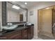 Bathroom featuring dual vessel sinks, granite countertops, and a decorative framed mirror at 8337 E Shetland Trl, Scottsdale, AZ 85258