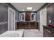 Beautiful bathroom with modern tile accents, dual sinks, and a jacuzzi tub at 8337 E Shetland Trl, Scottsdale, AZ 85258