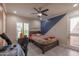 Bedroom with gray tile flooring, a ceiling fan, and an accent wall at 8337 E Shetland Trl, Scottsdale, AZ 85258
