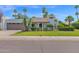 Charming home featuring a well-manicured lawn, mature palms, and a beige exterior at 8337 E Shetland Trl, Scottsdale, AZ 85258