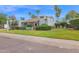 Charming home featuring a well-manicured lawn, mature palms, and a beige exterior at 8337 E Shetland Trl, Scottsdale, AZ 85258