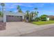 Charming home featuring a well-manicured lawn, mature palms, and a beige exterior at 8337 E Shetland Trl, Scottsdale, AZ 85258