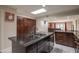 Well-equipped kitchen features an island with dark countertops, a skylight, and ample storage at 8337 E Shetland Trl, Scottsdale, AZ 85258