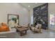 Bright living room featuring modern furniture, a striking stone fireplace and contemporary decor at 8337 E Shetland Trl, Scottsdale, AZ 85258