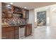 Open floor plan with a bar area and decorative fireplace, perfect for entertaining guests at 8337 E Shetland Trl, Scottsdale, AZ 85258