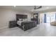 Main bedroom with gray wood-look flooring, dark gray furniture, and private backyard entrance at 8337 E Shetland Trl, Scottsdale, AZ 85258