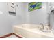 Bright bathroom with a white bathtub, grey walls, and modern fixtures, creating a clean, comfortable space at 11596 W Sierra Dawn Blvd # 307, Surprise, AZ 85378