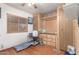 Cozy bedroom featuring wood paneling, ceiling fan, and a bright window, creating a warm and inviting atmosphere at 11596 W Sierra Dawn Blvd # 307, Surprise, AZ 85378