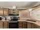 Updated kitchen with wood cabinets and a large window for natural light, perfect for any home chef at 11596 W Sierra Dawn Blvd # 307, Surprise, AZ 85378