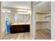 Bathroom featuring a double sink vanity and a separate closet for plenty of storage at 13676 N 73Rd Dr, Peoria, AZ 85381