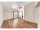 Comfortable bedroom with wood-look floors, natural light from the window, and ample closet space at 13676 N 73Rd Dr, Peoria, AZ 85381