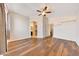 Spacious bedroom featuring hardwood floors, a ceiling fan, and neutral paint colors at 13676 N 73Rd Dr, Peoria, AZ 85381