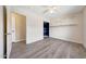 Spacious bedroom boasting gray wood floors, white walls, a closet and shelving for storage at 13676 N 73Rd Dr, Peoria, AZ 85381