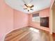 Bedroom featuring hardwood floors, a ceiling fan, and a window for natural light at 13676 N 73Rd Dr, Peoria, AZ 85381