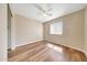 Bedroom with a ceiling fan, window with blinds, and hardwood floors at 13676 N 73Rd Dr, Peoria, AZ 85381