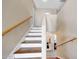 Staircase featuring wood treads and white risers, providing access to the upper level of the home at 13676 N 73Rd Dr, Peoria, AZ 85381