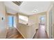 Upper level hallway featuring beautiful wood floors, archways, and natural light at 13676 N 73Rd Dr, Peoria, AZ 85381