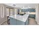 Modern kitchen with light blue cabinets, quartz countertops, stainless steel appliances and pendant lighting at 13676 N 73Rd Dr, Peoria, AZ 85381
