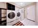 Functional laundry room featuring a washer, dryer, and additional storage for convenience at 13676 N 73Rd Dr, Peoria, AZ 85381