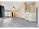 Bright living room featuring wood-look floors, high ceilings, view to stairs, and natural lighting at 13676 N 73Rd Dr, Peoria, AZ 85381