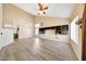 Spacious living room with high ceilings, wood-look floors, and natural light from large windows at 13676 N 73Rd Dr, Peoria, AZ 85381