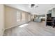 Spacious living room featuring modern flooring, natural light, and an open concept layout into the kitchen at 13676 N 73Rd Dr, Peoria, AZ 85381