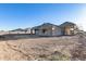 Backyard view of a new house featuring an empty yard ready for landscaping and a covered patio at 14723 N 73Rd Dr, Peoria, AZ 85381