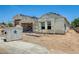 New home showcasing a frame and garage, with a large dumpster nearby at 14723 N 73Rd Dr, Peoria, AZ 85381