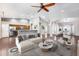 Bright open-concept living room featuring wood floors, decor, and seamless flow to kitchen and dining area at 22616 S 194Th St, Queen Creek, AZ 85142
