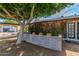 View of the front exterior of the home, highlighting the mature tree providing shade to a charming courtyard at 2938 N 18Th Ave, Phoenix, AZ 85015