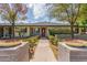 Traditional single-story home featuring a red front door, lush front yard, and mature shade trees at 2938 N 18Th Ave, Phoenix, AZ 85015