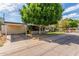 Charming single-story home featuring a spacious carport and mature trees in a well-maintained front yard at 2938 N 18Th Ave, Phoenix, AZ 85015
