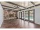 Bright living room features a stone fireplace, beamed ceilings, and access to the outdoor pool area at 2938 N 18Th Ave, Phoenix, AZ 85015