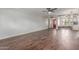 Open-concept living room with dark wood floors, a ceiling fan, and a bright red front door at 2938 N 18Th Ave, Phoenix, AZ 85015