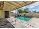 A covered patio overlooks the private in-ground swimming pool in the backyard at 2938 N 18Th Ave, Phoenix, AZ 85015