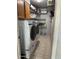 Functional laundry room with washer, dryer, and shelving at 955 W Obispo Ave, Mesa, AZ 85210